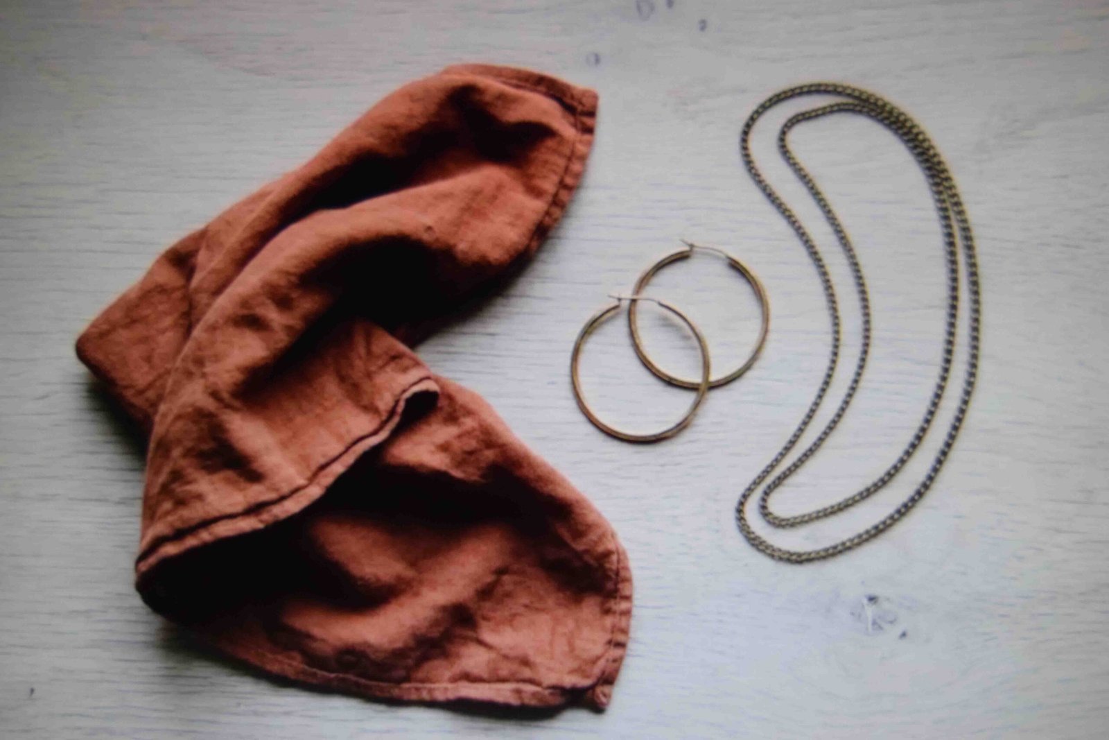 A bandana hoop earrings and layered chains as the three accessories to pick