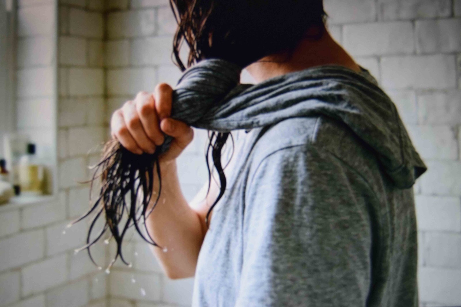 Hair being squeezed dry with a cotton tee before any styling begins