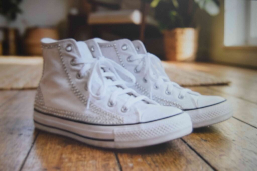 White sneakers customised with side crystals for a bedazzled sneakers diy project