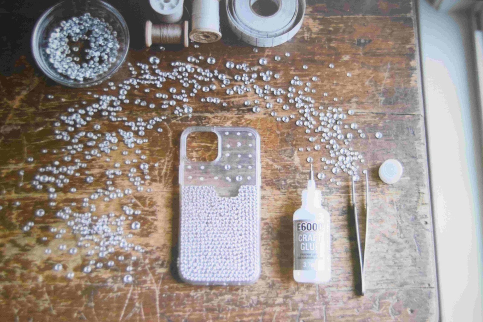 Craft table set up with rhinestones and tools for bedazzling ideas