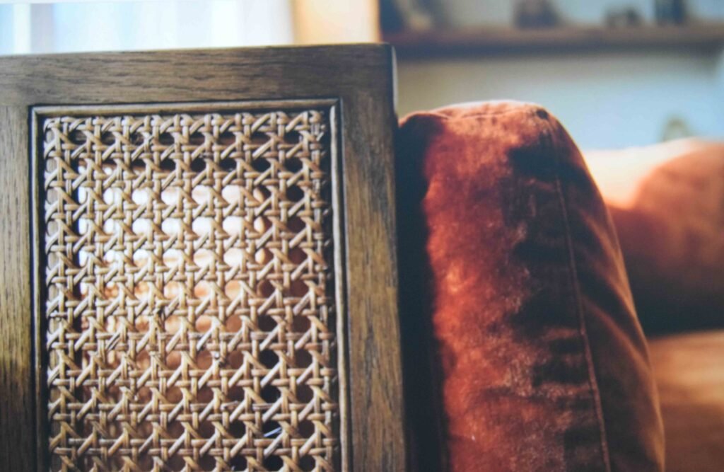 Cane weave paired with smooth velvet to balance texture in a vintage apartment aesthetic
