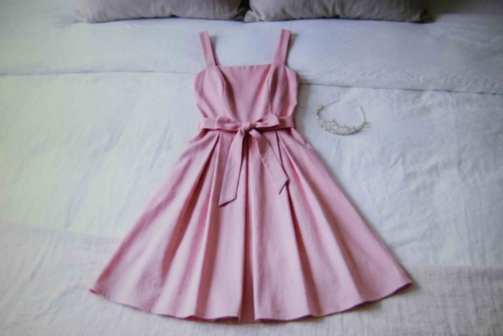 A pink dress with a sash and tiara built as an archetype rather than a licensed costume