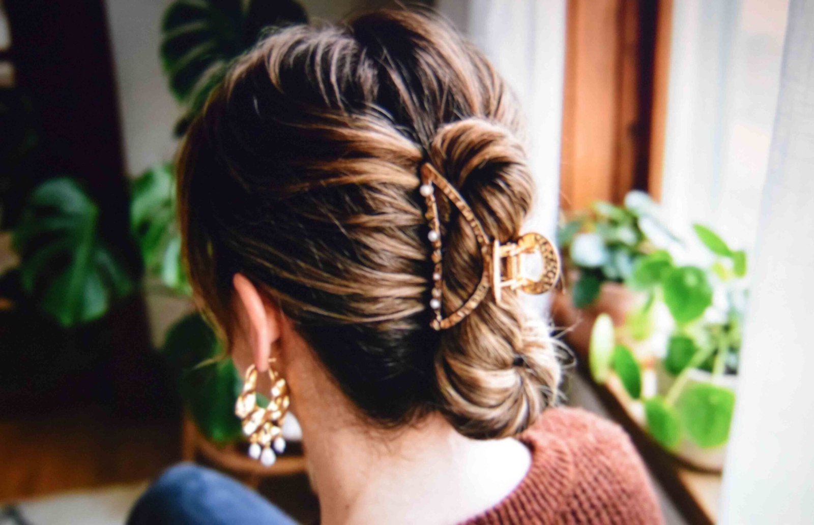 A claw clip holding twisted hair with height built through the crown