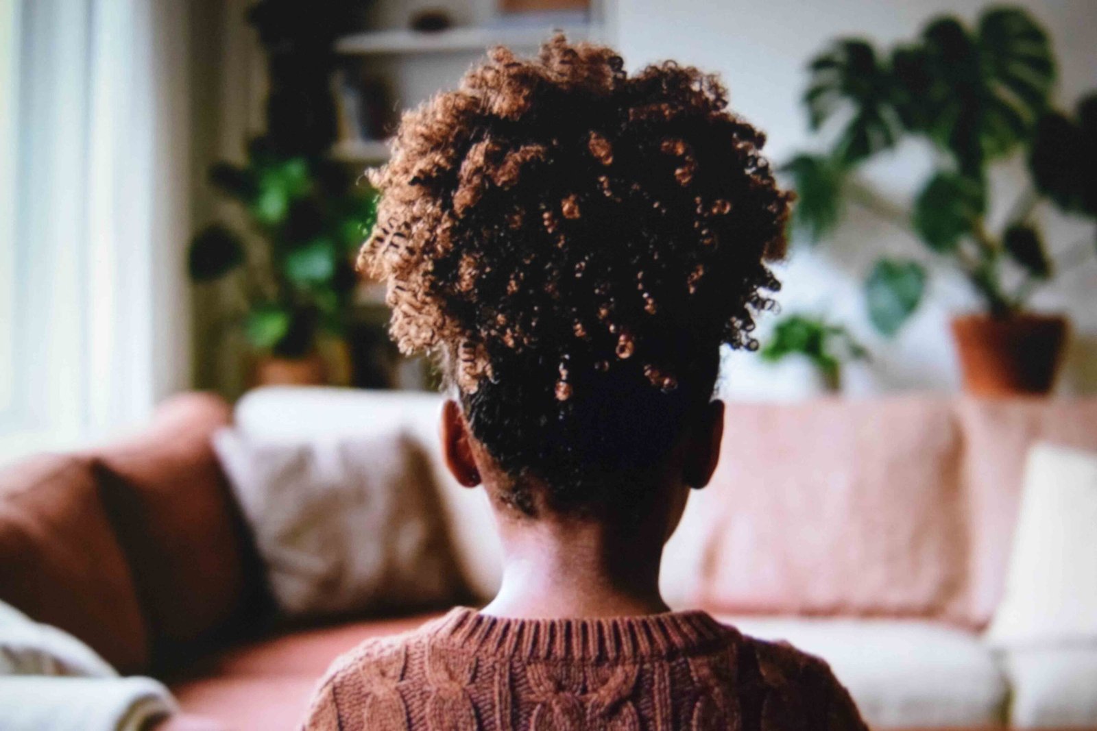 Rounded curly puff ponytail sitting high on a child's crown