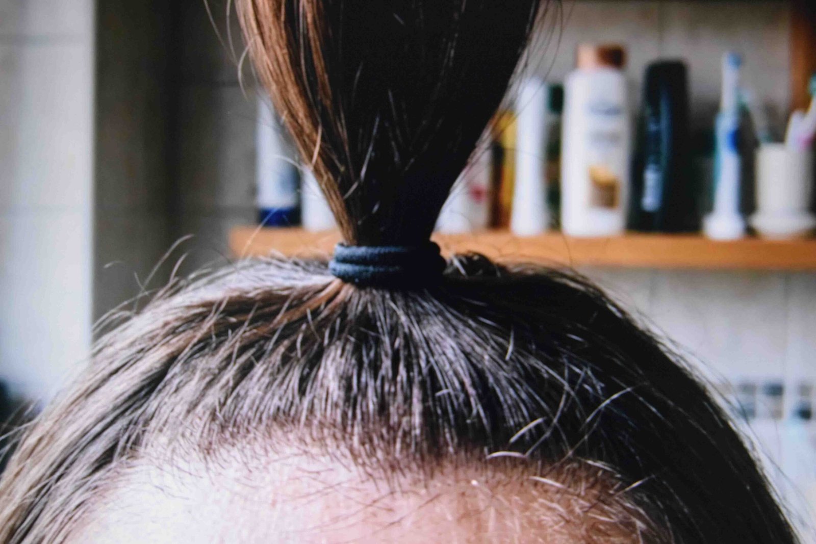 A close view of a band holding a section without pulling the scalp