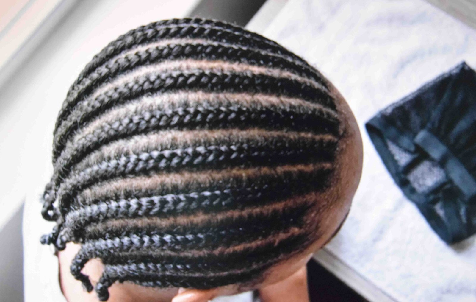 Hair banded in flat level rows ready for a cap to go over it