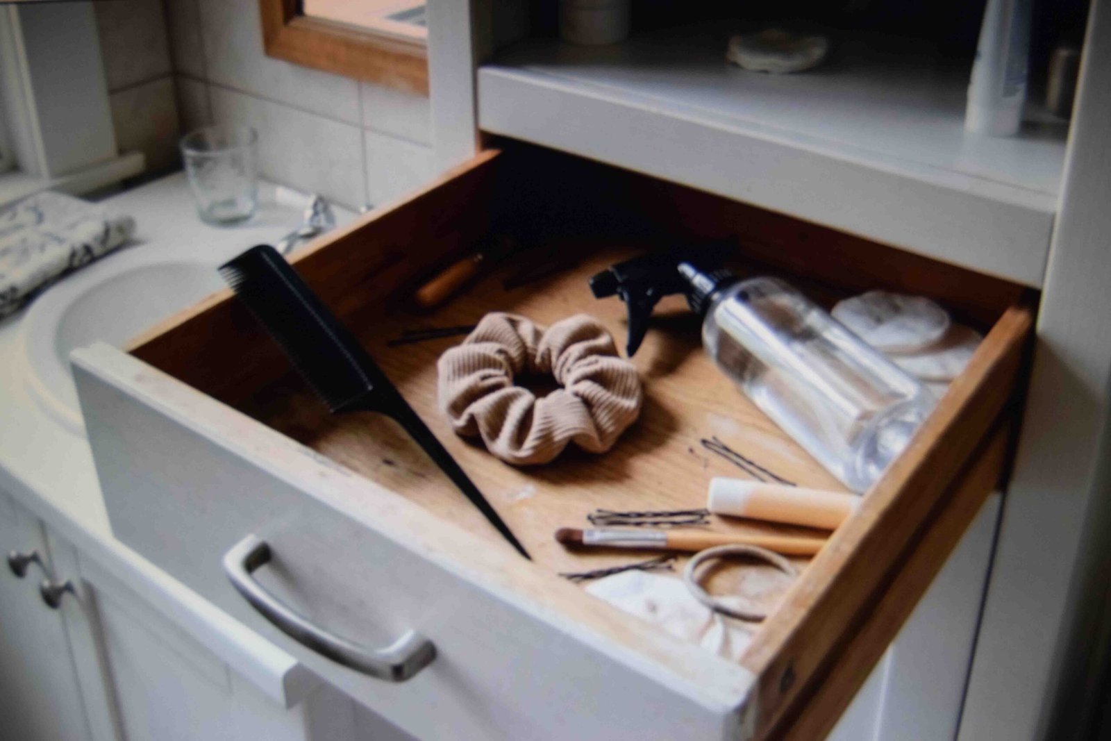 An open drawer holding the few tools that replace styling gel