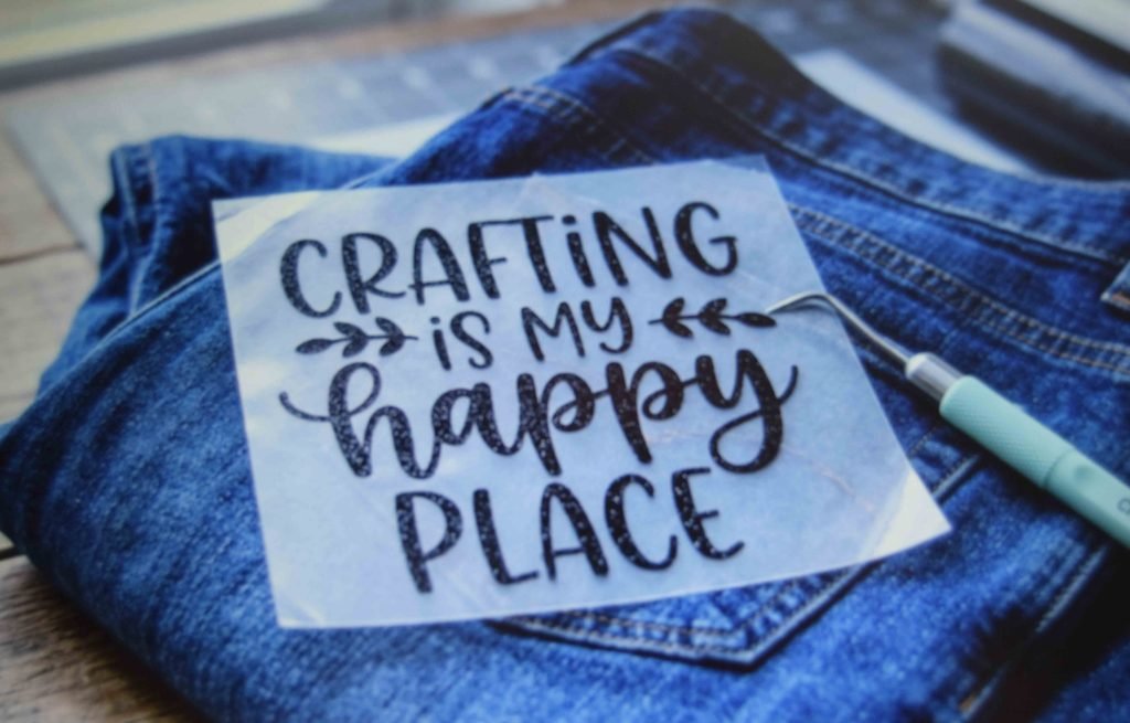 Weeded heat transfer vinyl lettering ready to press onto a denim back pocket