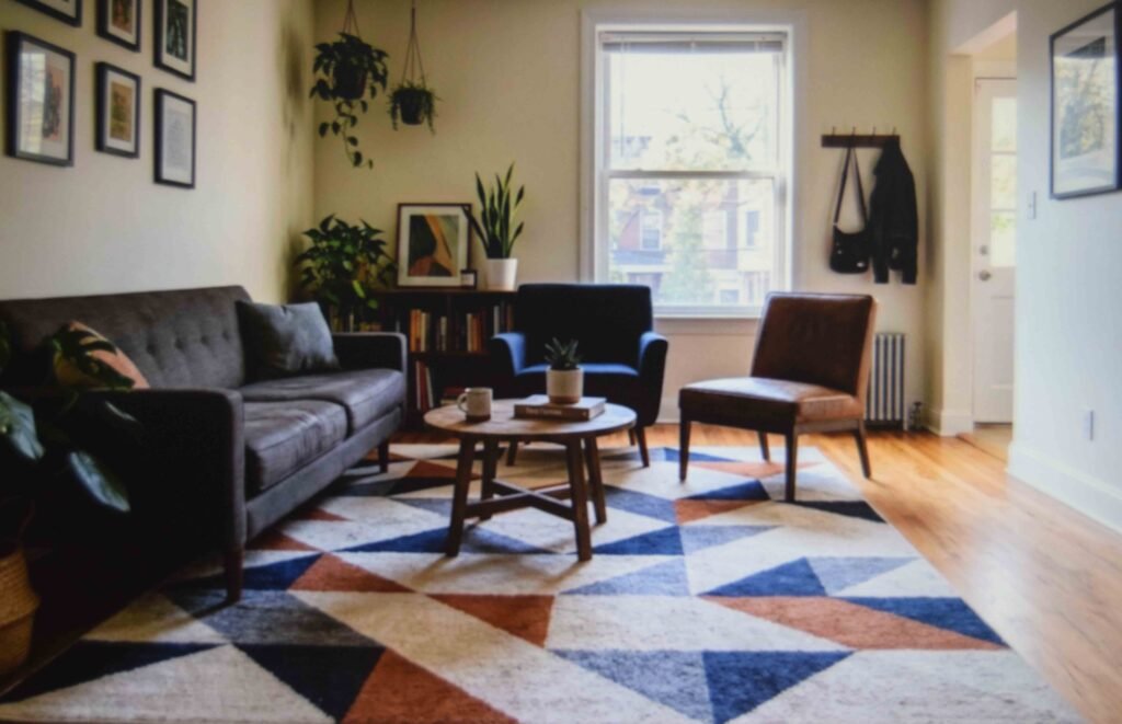 A large geometric rug defining the seating zone in a compact apartment living room