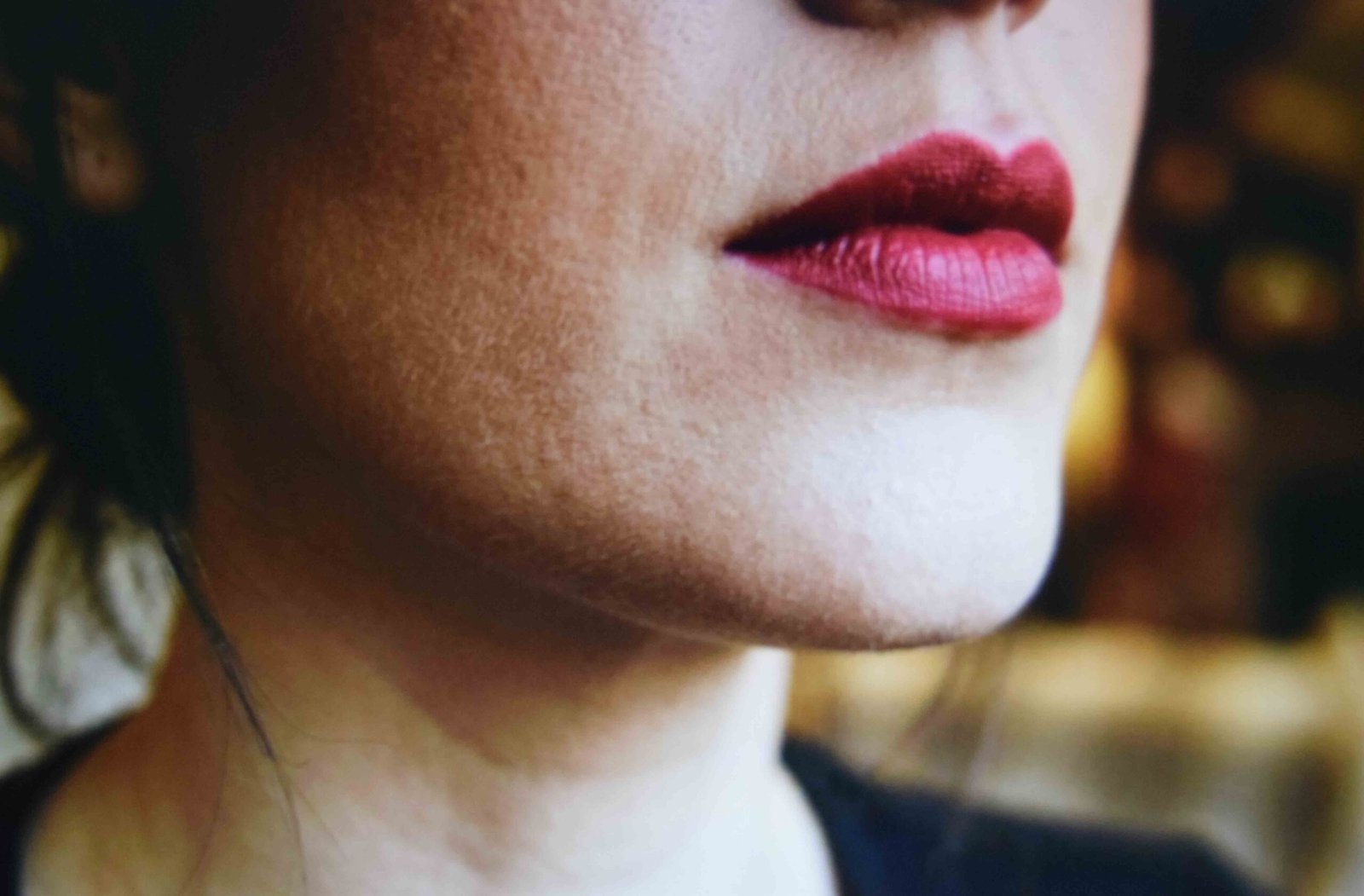 Graphic eyeliner and a berry lip chosen to hold up against pink hair