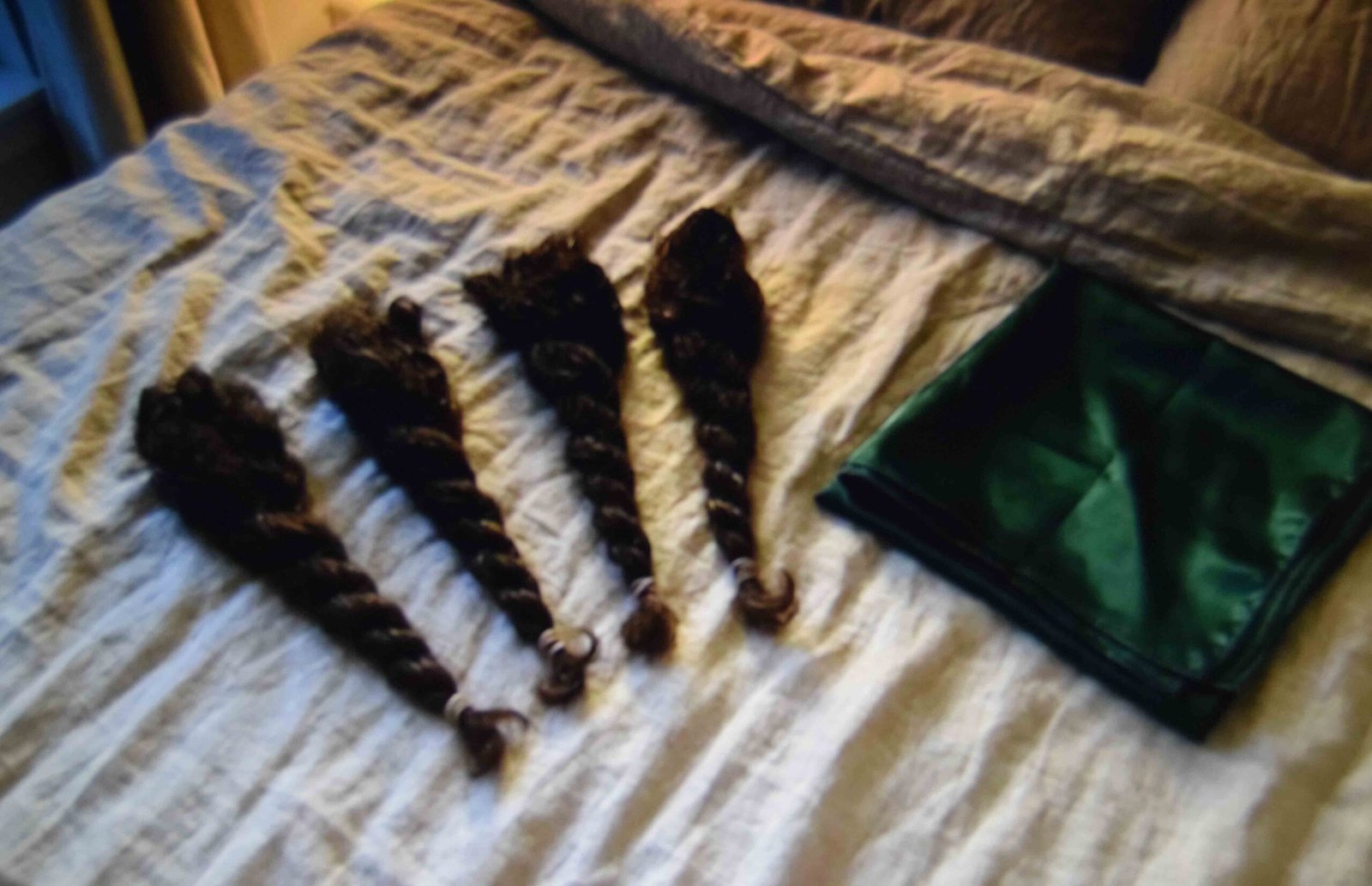 Four twists fastened for overnight setting next to a folded satin scarf