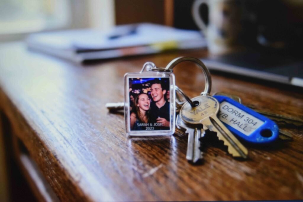A photo keychain clipped to dorm keys as a portable piece of a graduation keepsake