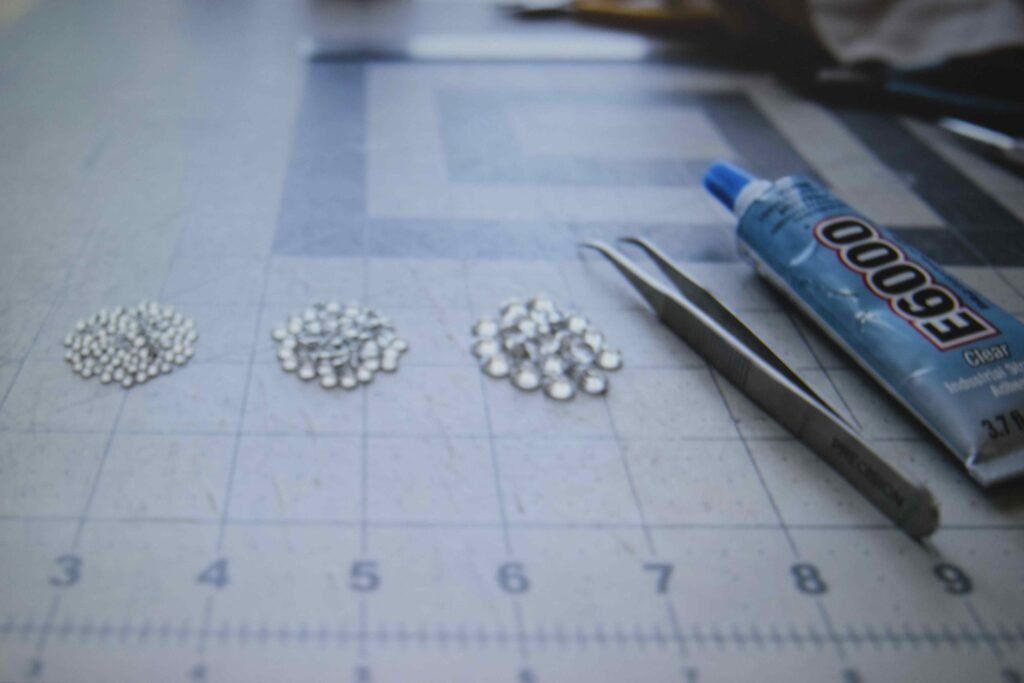 Crystals sorted by size next to glue and tweezers