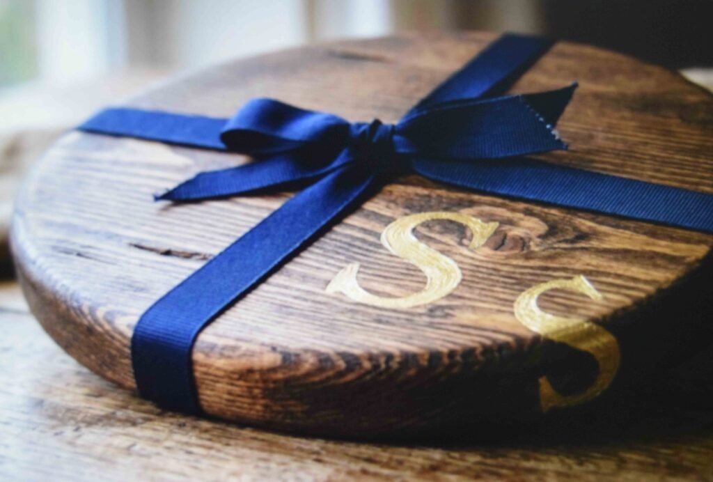 A stained wooden lid finished with school colors used only in the ribbon and lettering
