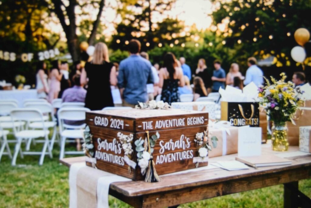 A finished keepsake box placed on the gift table at an outdoor graduation party