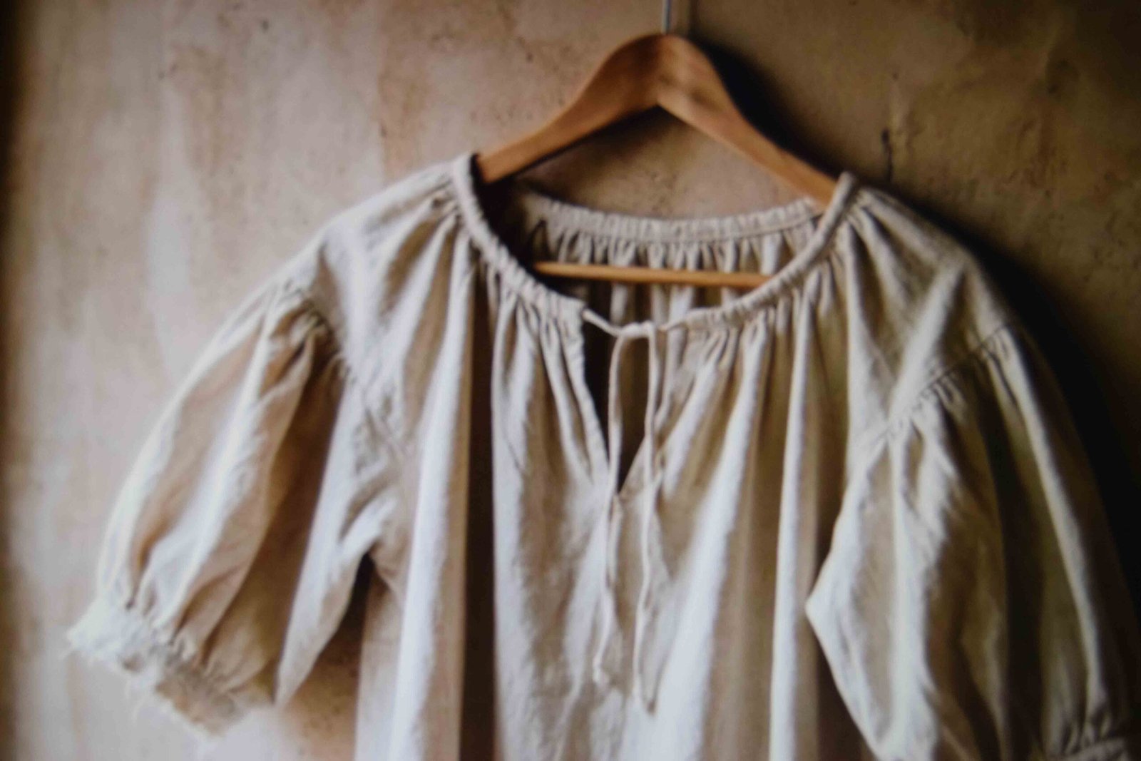 A pirate blouse with billowy sleeves and a laced neckline hanging ready