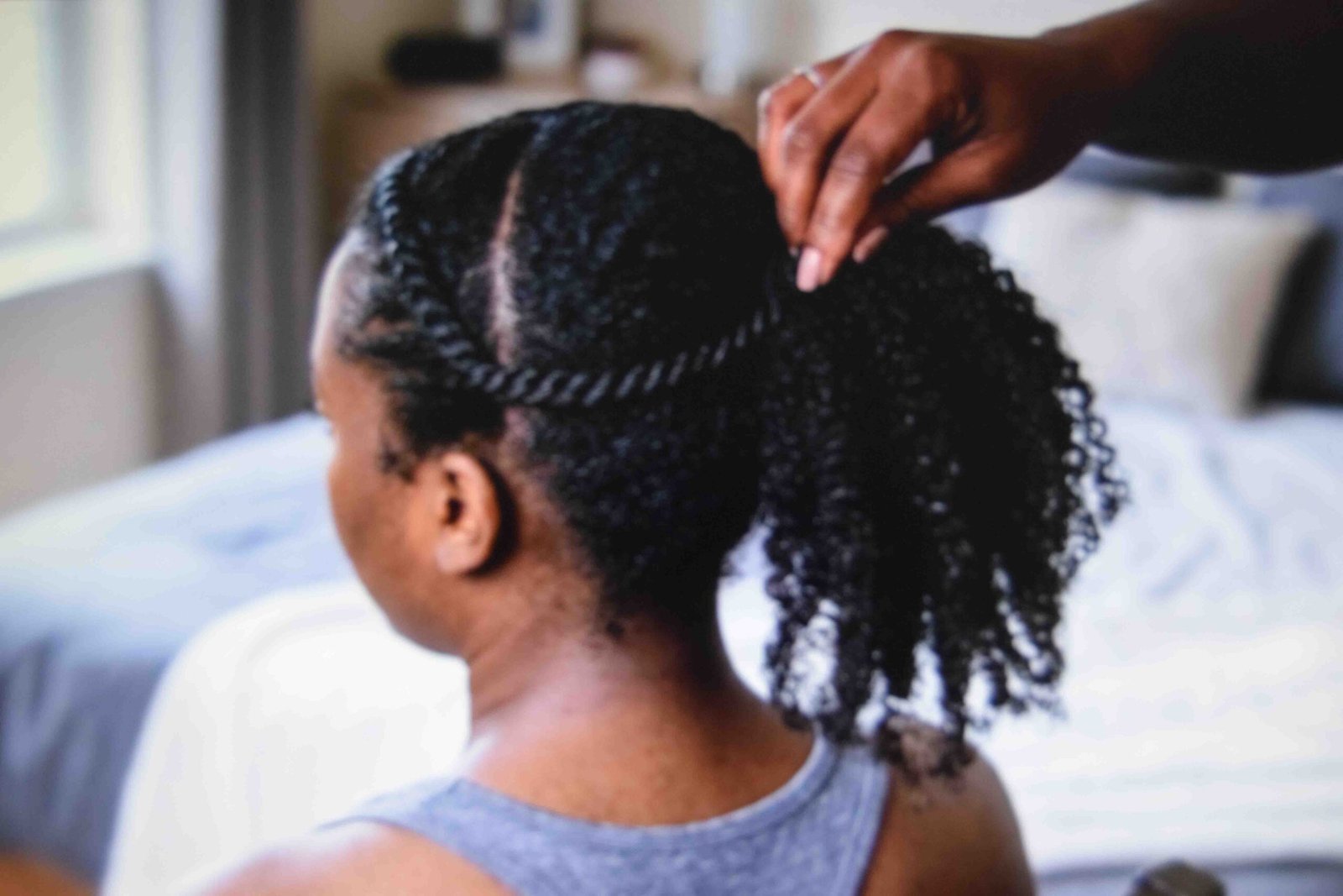 Two-strand twist along the hairline feeding into a high ponytail