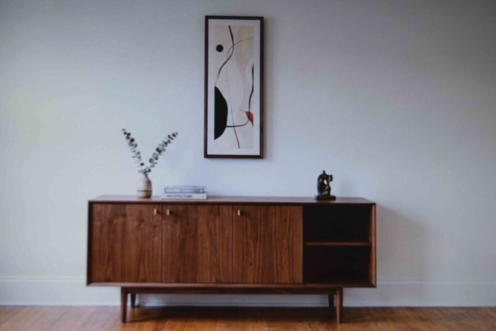 A low walnut credenza with clear wall space on either side to keep its proportions visible
