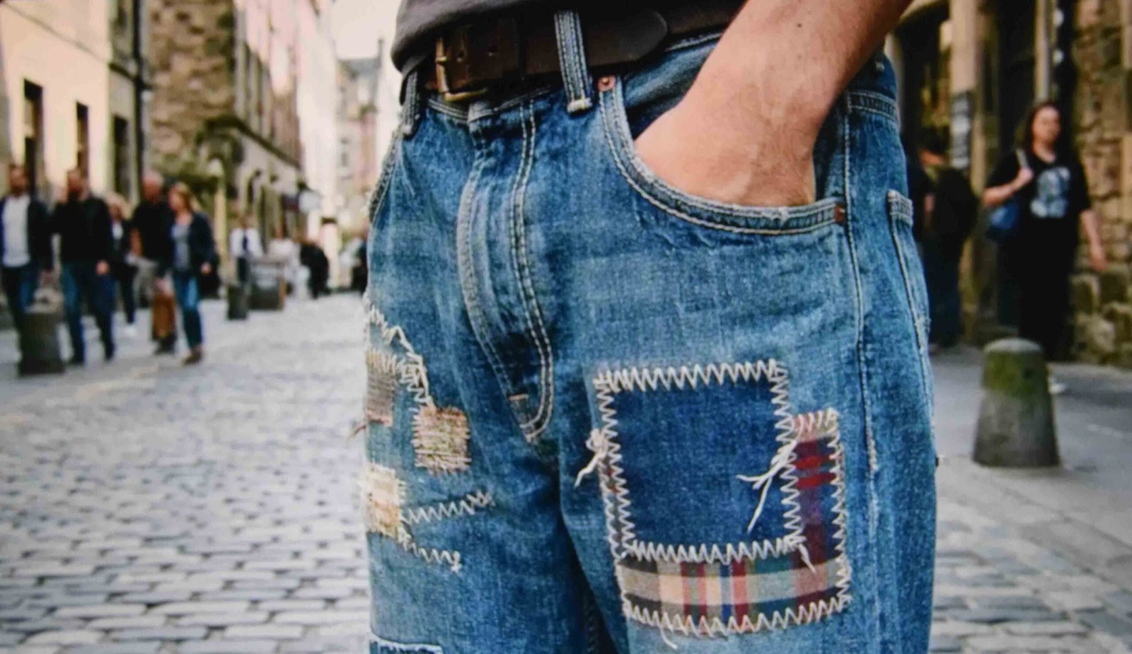 Patchwork detailing on baggy jeans with designs paired with a plain top