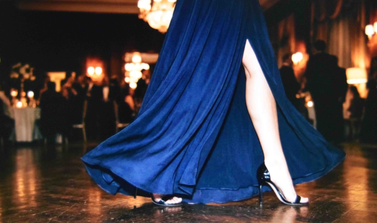 A black tie gown hem with a slit that allows a full stride