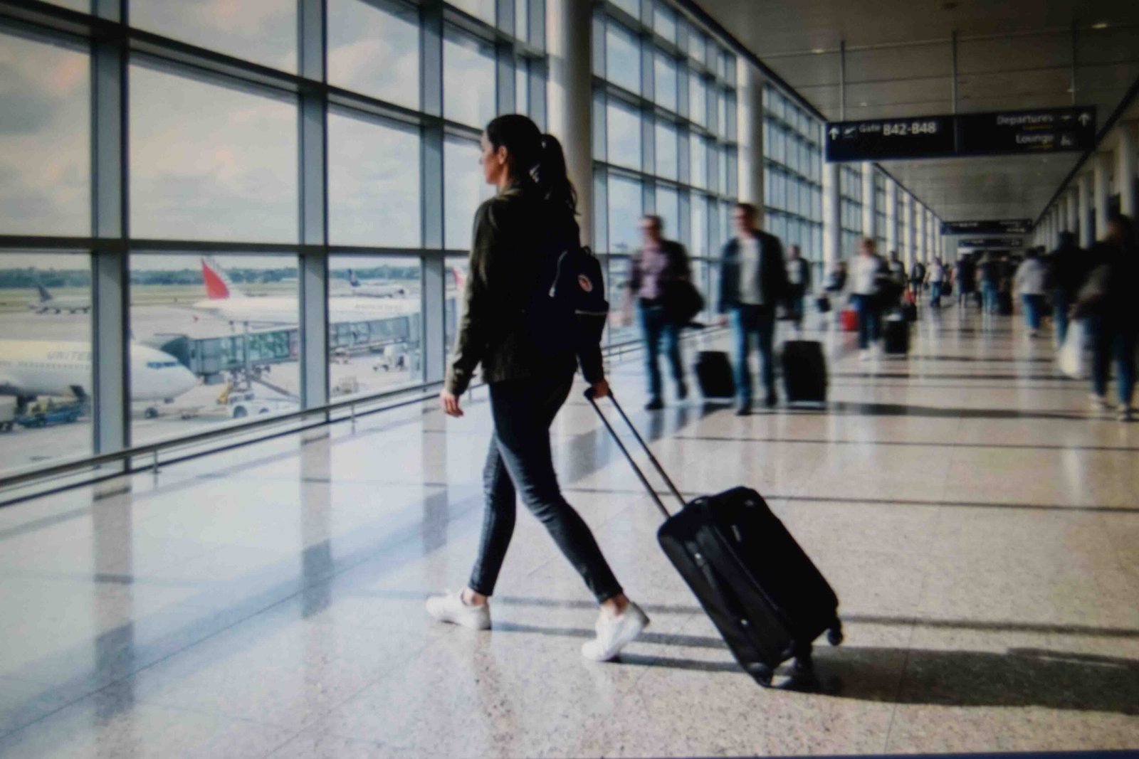 A traveller walking a terminal in one of the more comfortable airport outfits