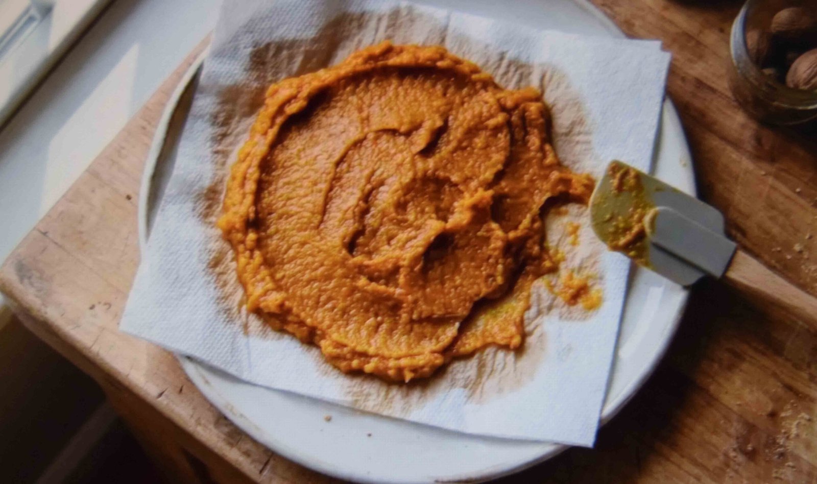 Draining excess water from pumpkin puree before mixing a loaf batter