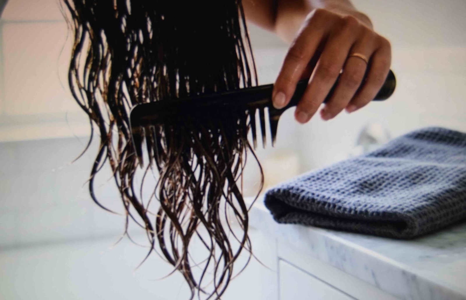 Detangling with a wide tooth comb as part of hair care for natural hair