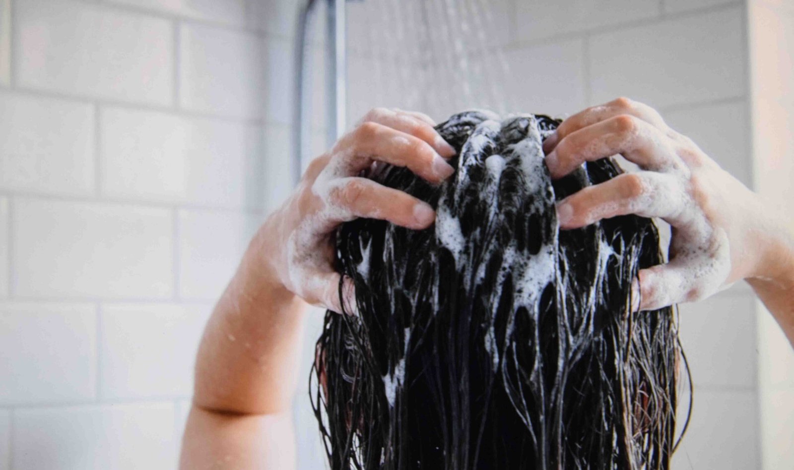 Washing the scalp rather than the length as part of how to care for oily hair