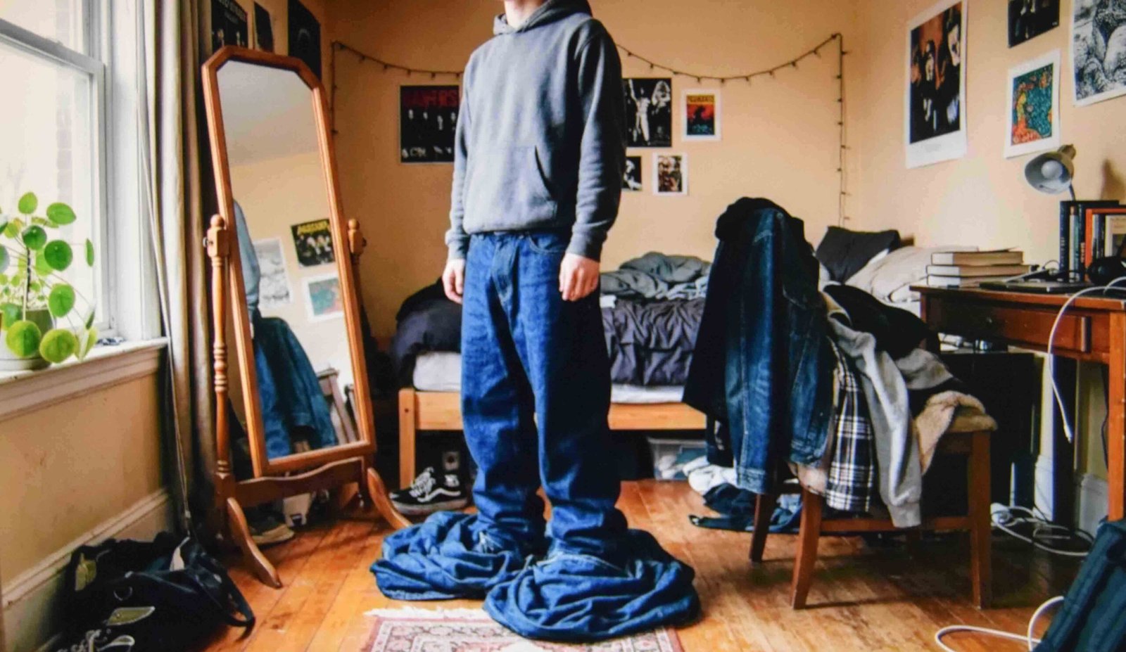 Checking proportions in a mirror before working out how to style baggy jeans