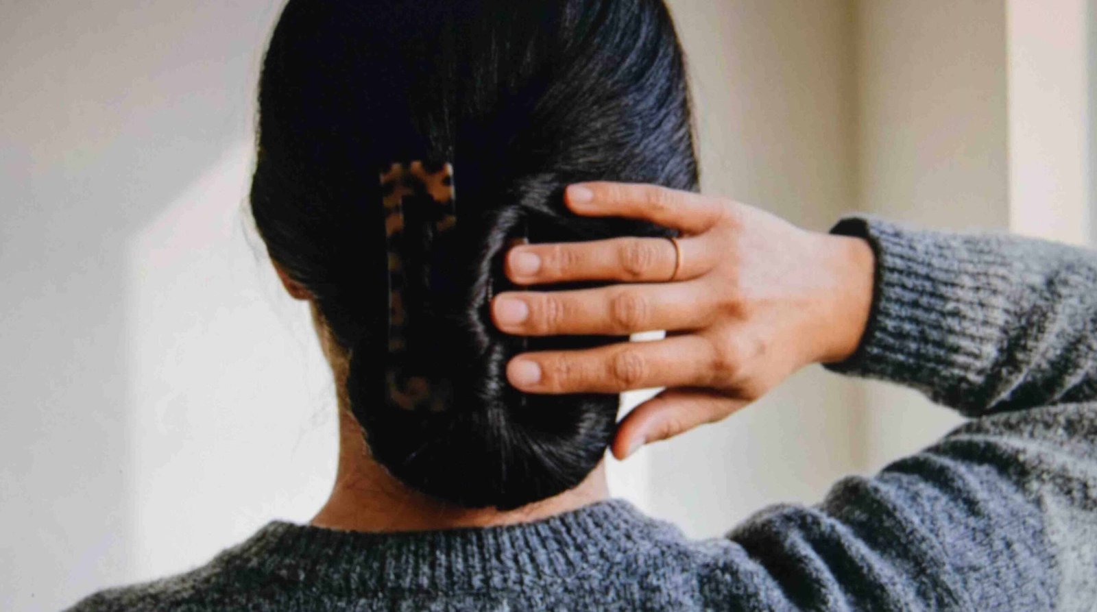 Waist length hair twisted and wrapped once around a claw clip to take weight off the teeth