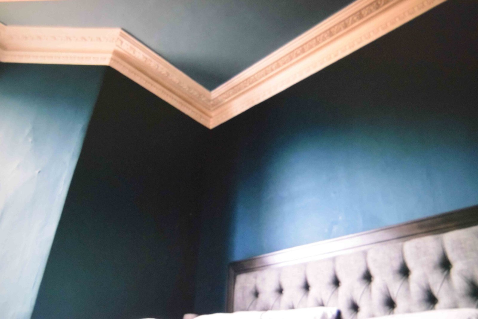 Ceiling painted to carry the wall shade across the join in a master bedroom interior