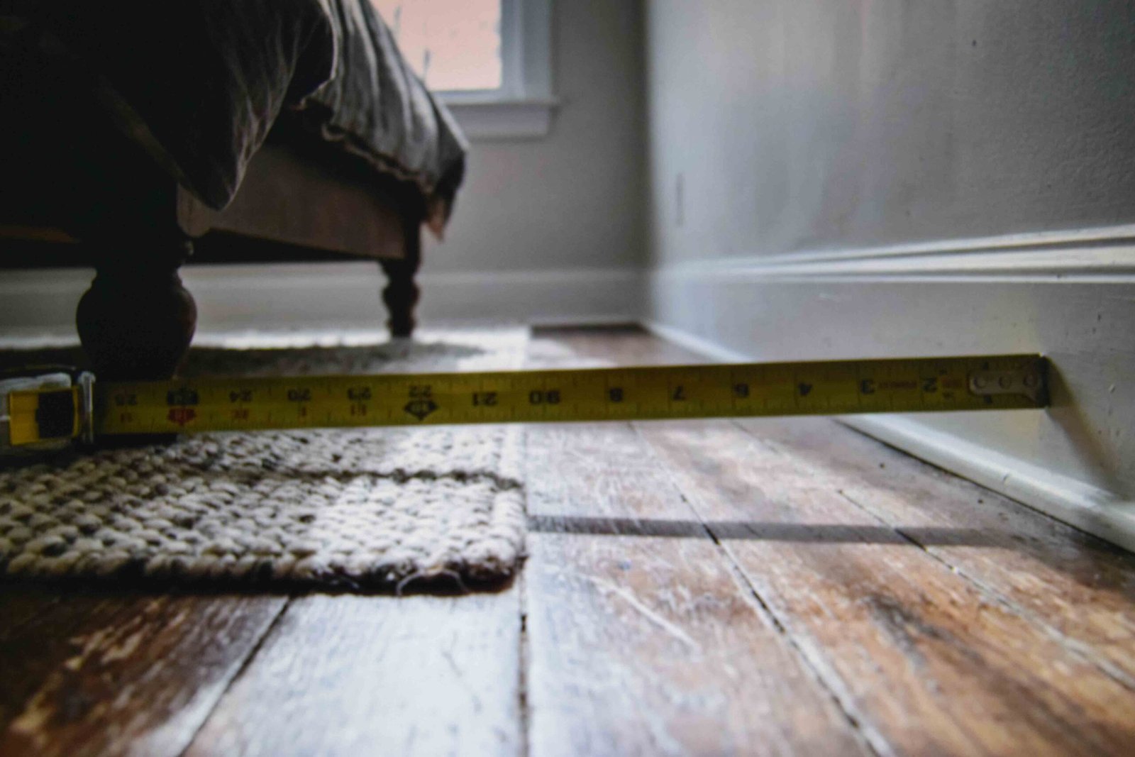 Tape measure checking side clearance for a master bedroom plan with dimensions