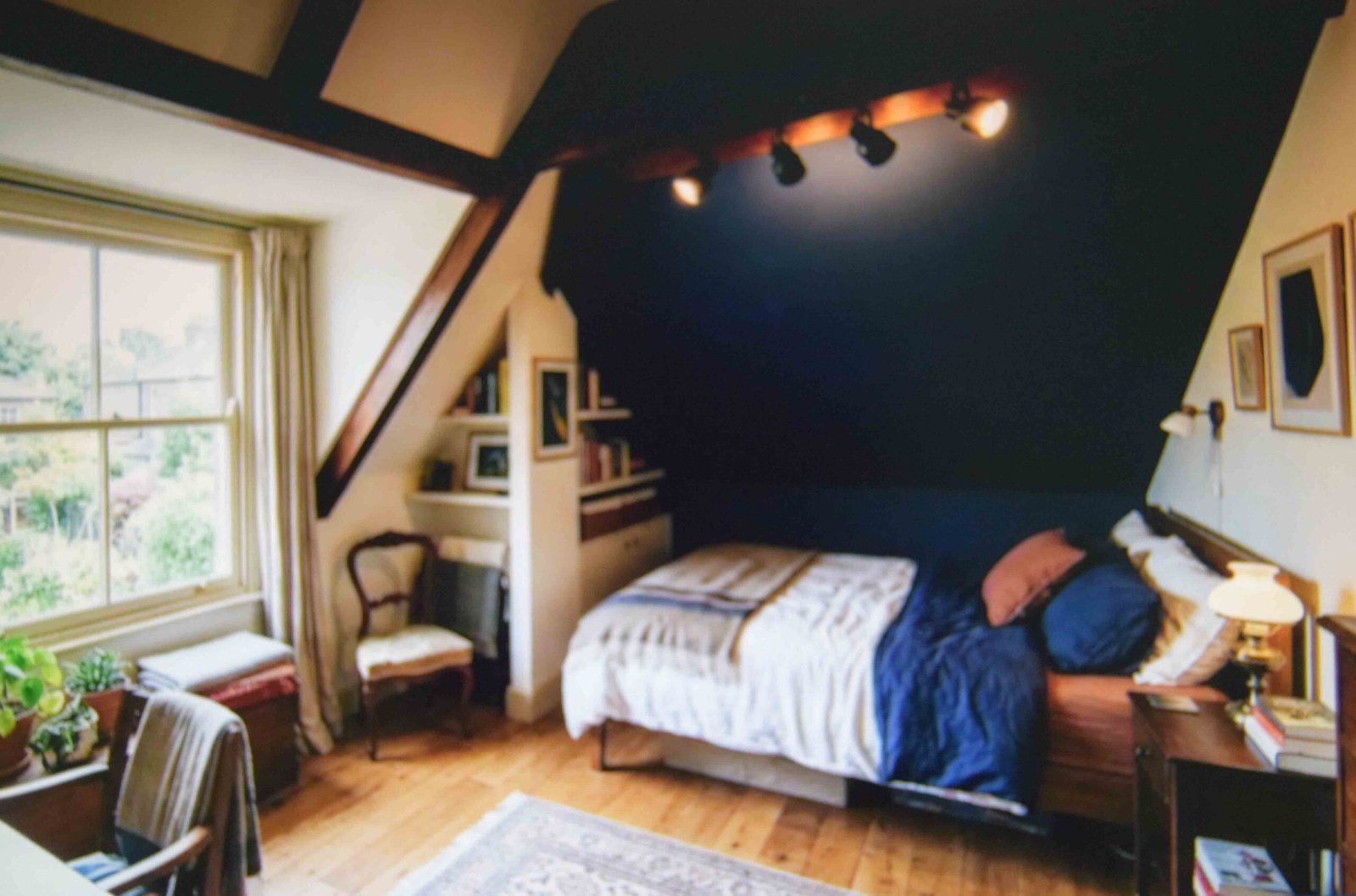 Sloped ceiling and beam turned into a feature in a bedroom interior design
