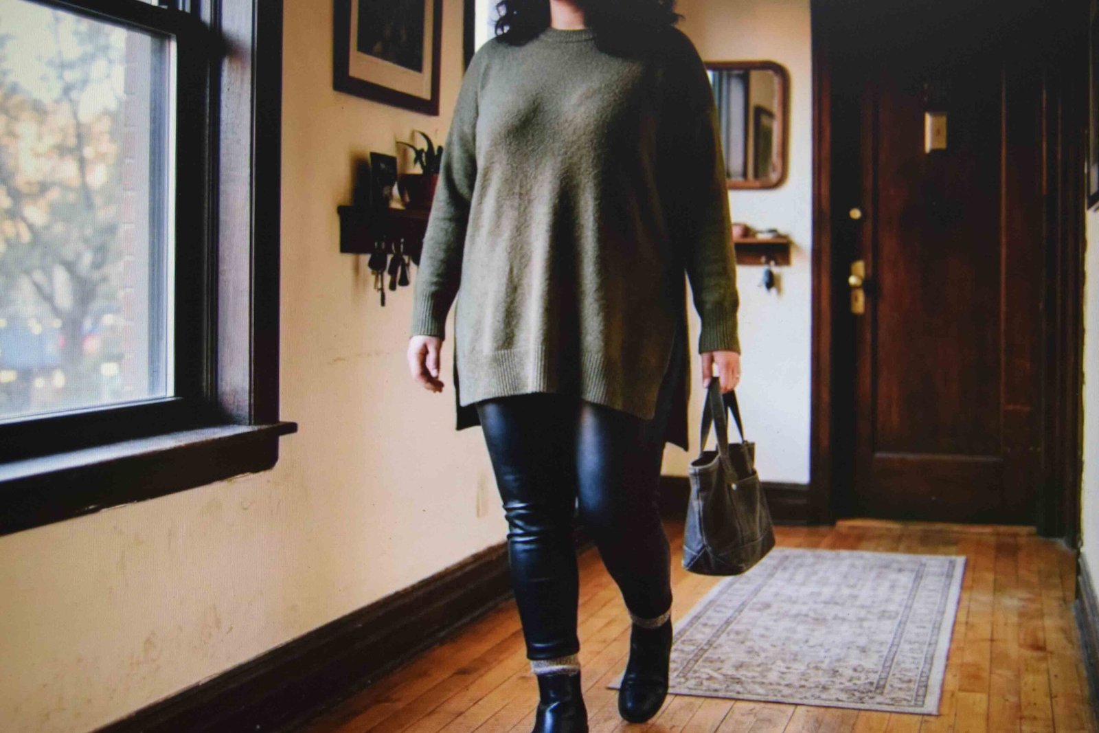 Leather look trousers styled with a longer knit as plus size going out clothes