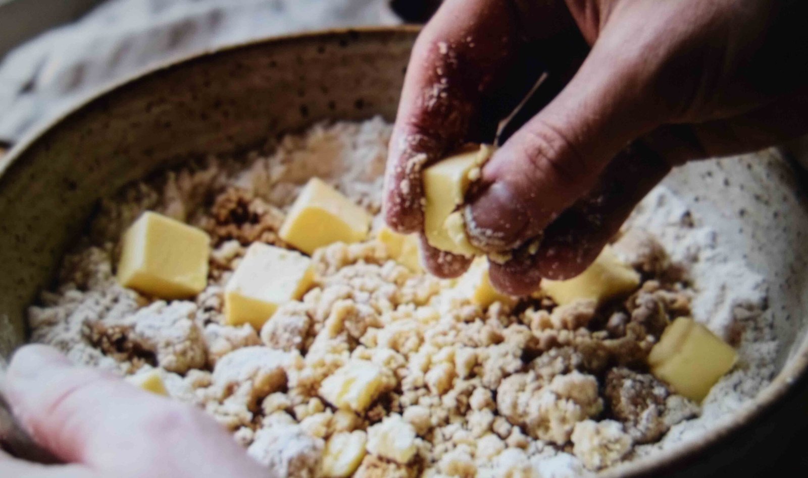 Cold butter rubbed into flour to make a pumpkin bread streusel topping that stays crisp