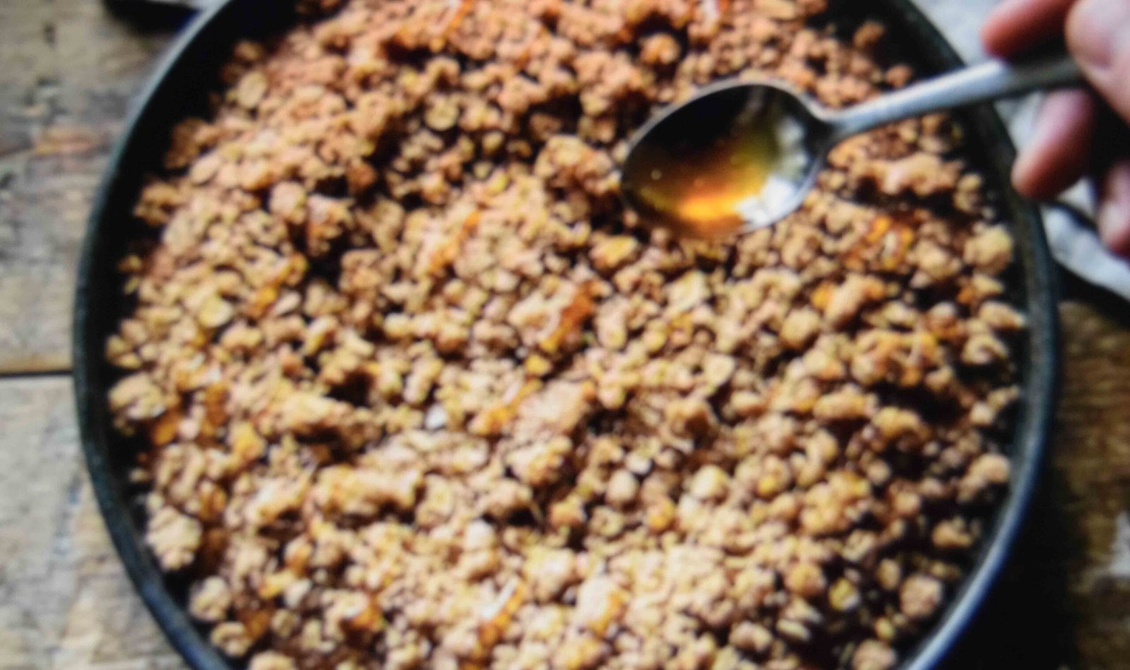 Maple glaze drizzled in lines over a pumpkin bread with streusel topping
