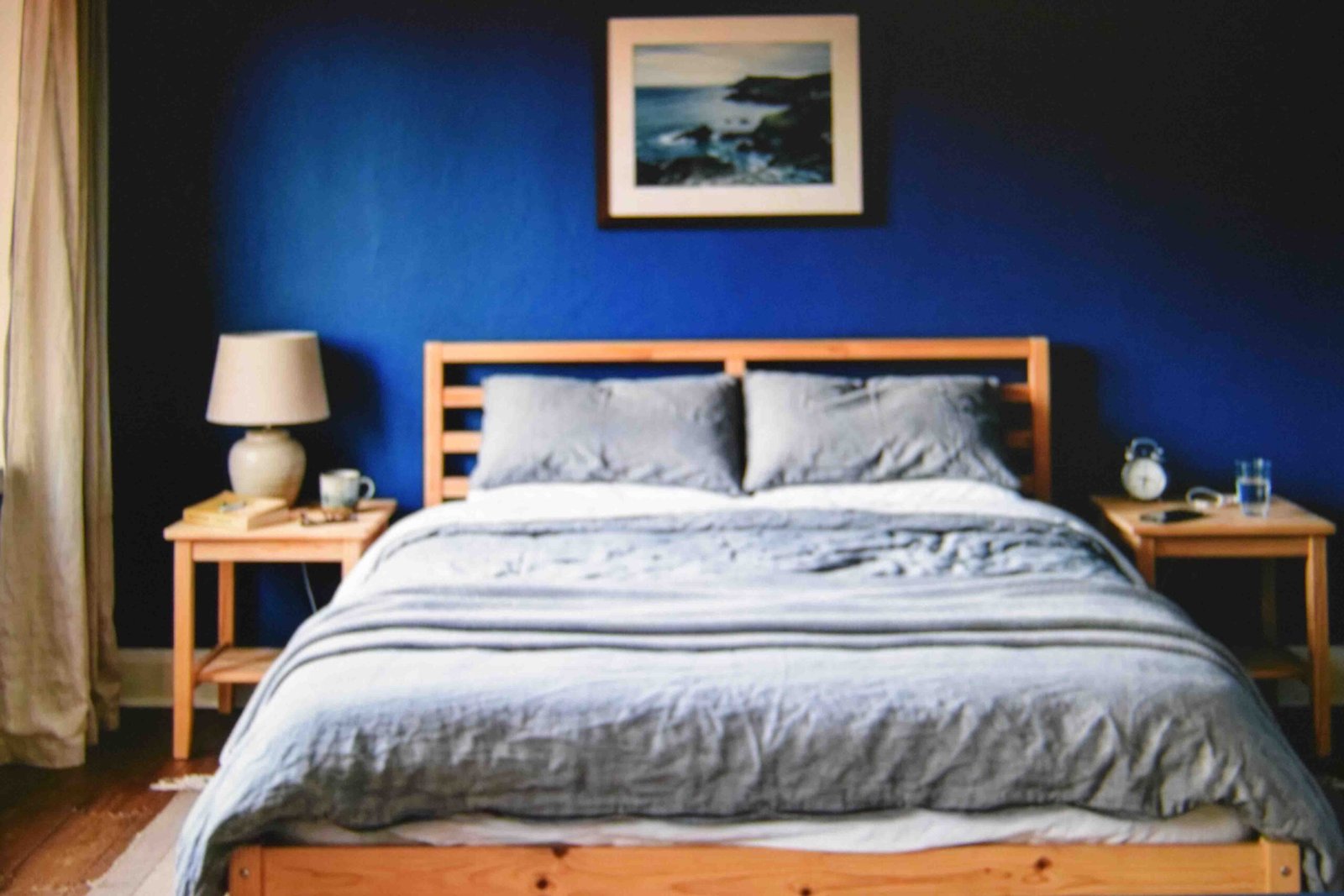 Basic furniture in a saturated blue room showing simple master bedroom ideas that work